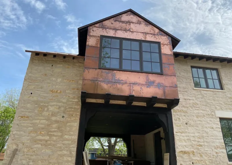 Copper metal panel facade on a stone building for Skylight Installation in Merced